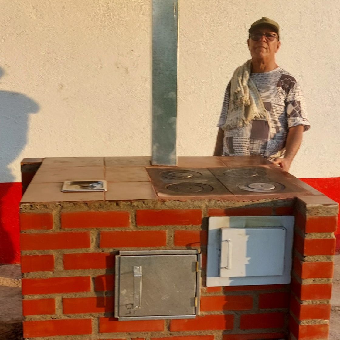 Señor posando en estufa ecoeficiente